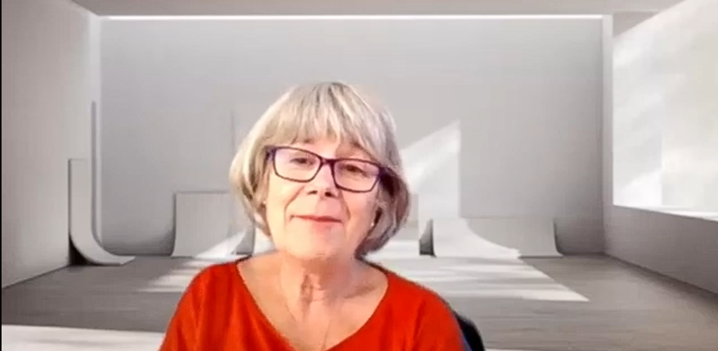 Louise talking to the camera wearing a red top