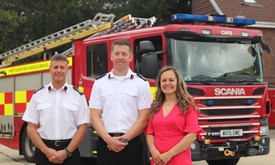 Assistant Chief Fire Officer Andy Piller, Interim Chief Fire Officer Gary Ball, and Assistant Director Sabrina Pennington-Down stood in front of a fire engine