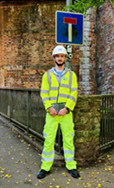 Man standing in front of a bridge