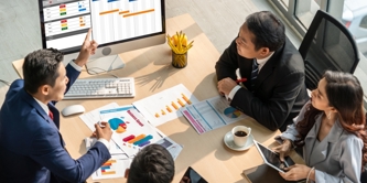 People sat around a computer