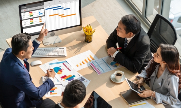 People sat around a computer