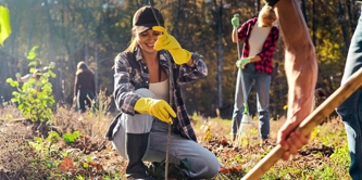 Young female tree planting with mixed group of people