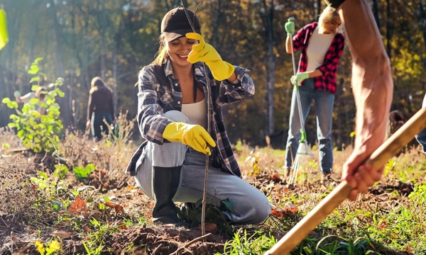 Young female tree planting with mixed group of people