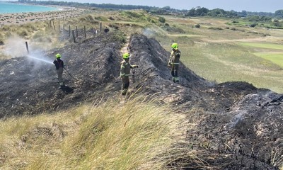 Firefighters damping down the landscape after a fire at West Beach Littlehampton