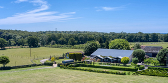 Aerial view of Selden barns with a helicopter.