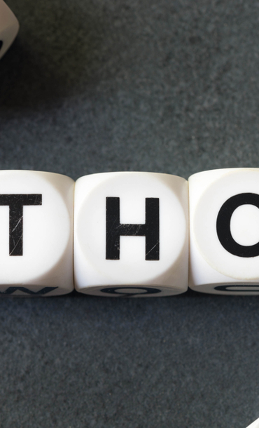 The word 'ethos' spelt out with white cubes and black letters on each cube.