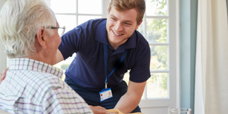 A male nurse looking at an elderly male
