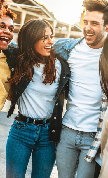 Male and female group with arms around each other and smiling.