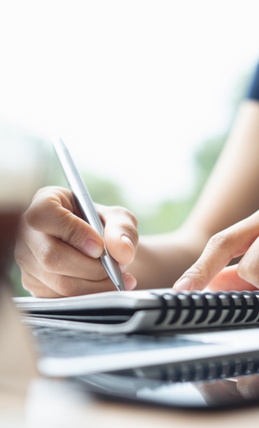 Woman writing in in notebook
