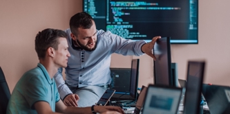 2 men looking at computer screens