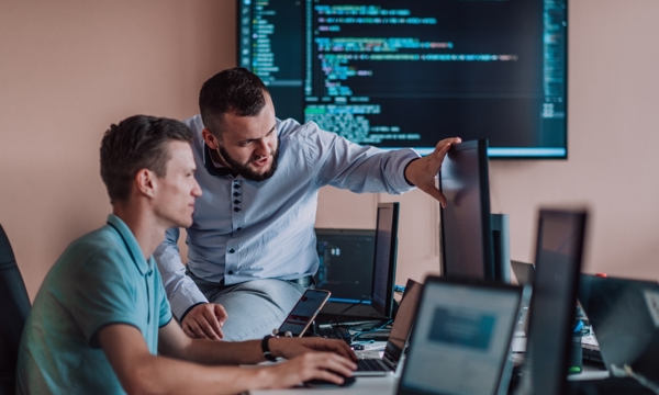 2 men looking at computer screens