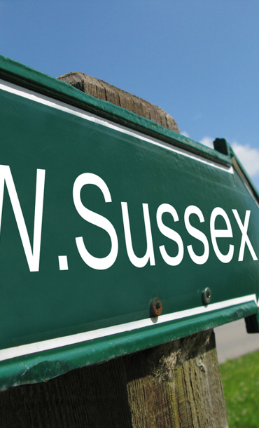 Green West Sussex sign pointing towards the top-right.
