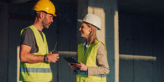 Two constructions workers talking to each other