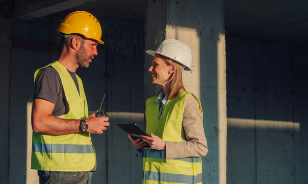 Two constructions workers talking to each other