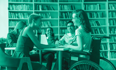 Group of young people chatting in a library