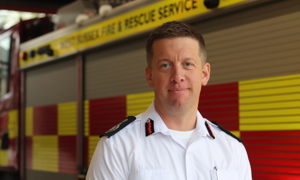 Interim CFO Gary Ball stood in front of a fire engine