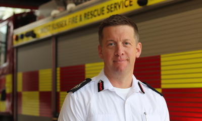 Interim CFO Gary Ball stood in front of a fire engine