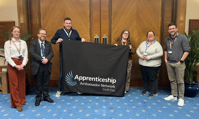 Group of people holding Apprenticeship banner