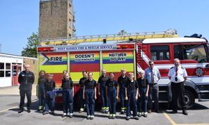 Young people standing in front of a fire engine