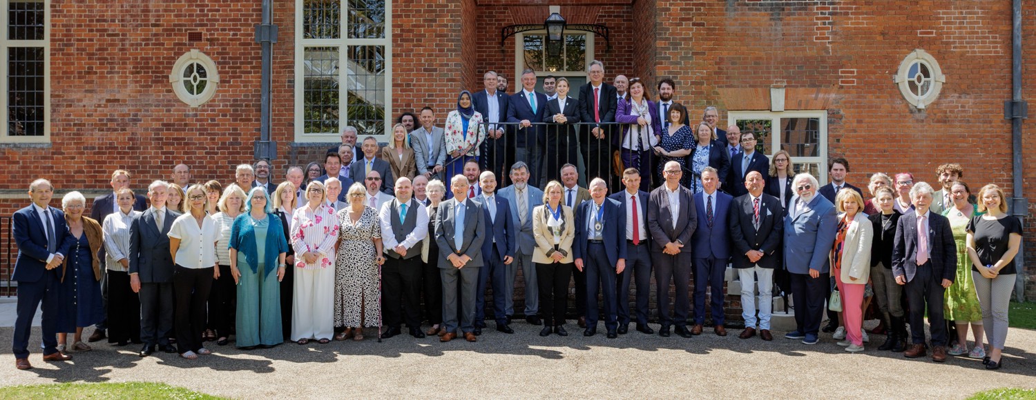 All West Sussex County Councillors standing in front of Edes House on the lawn outside County Hall, Chichester