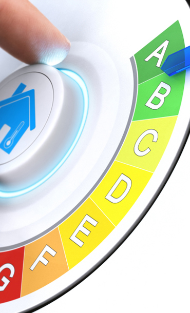 A hand turning a dial with a house symbol on for energy efficiency rating of A.