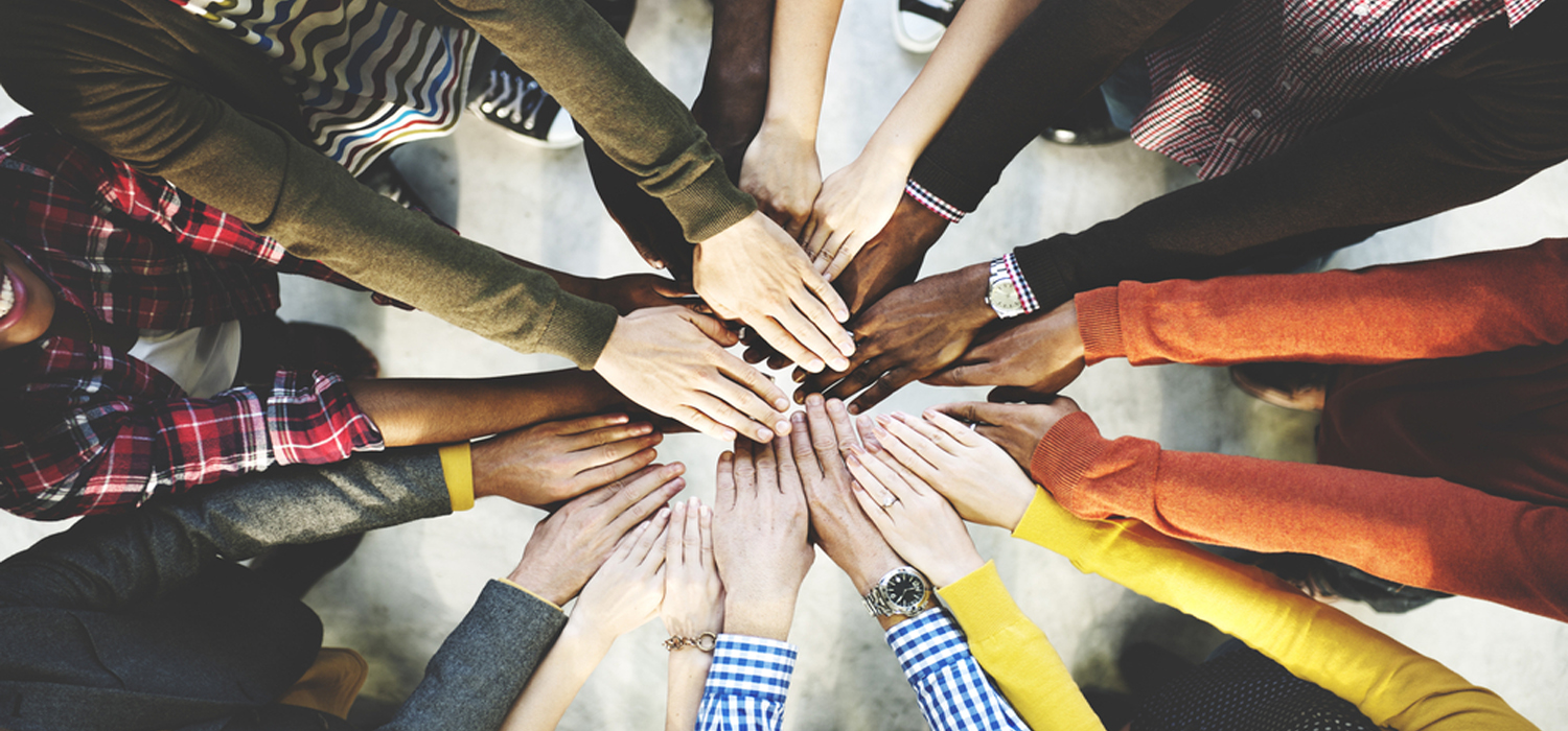 Group of people with outstretched arms
