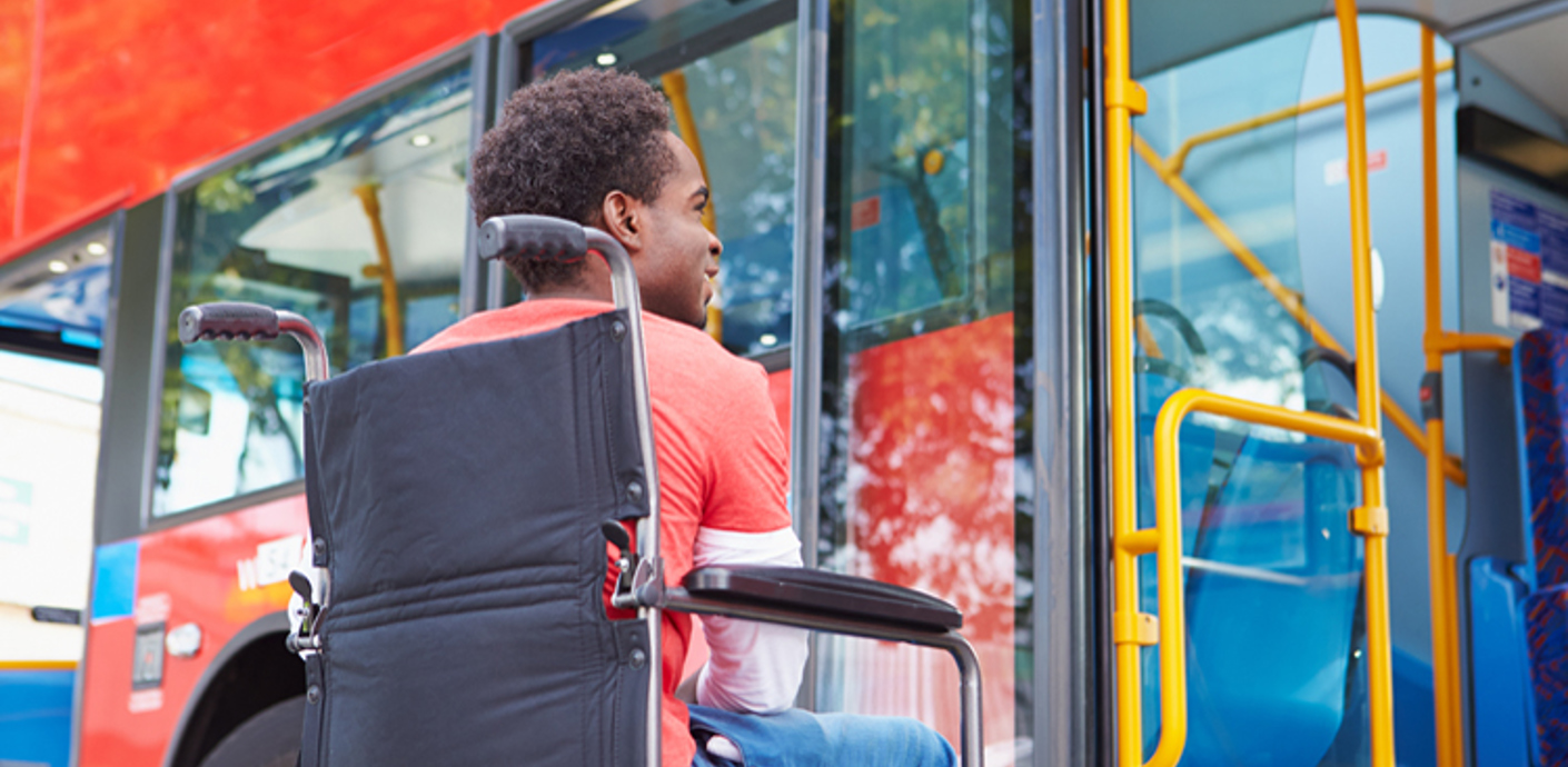 nojs Boy in wheelchair next to a bus