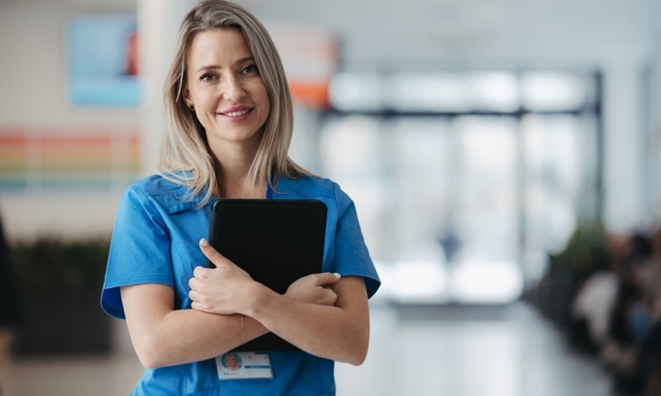 A female nurse holding a clipboard