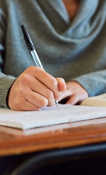 A teacher writing in a book.