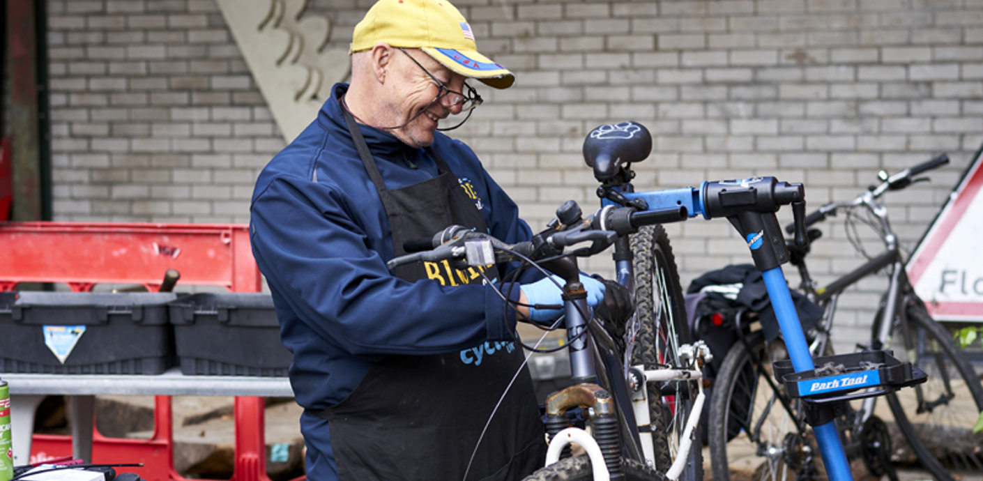 nojs Man working on a bicycle
