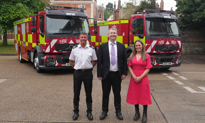 Area Manager Andy Piller, Councillor Duncan Crow and Interim Assistant Chief Officer Sabrina Pennington-Down standing in front of two water carriers
