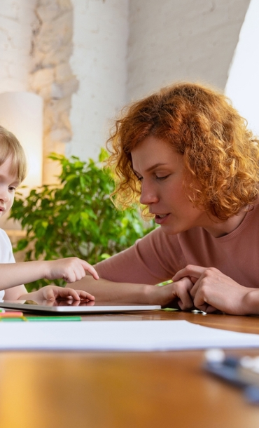 An adult helping an individual child.